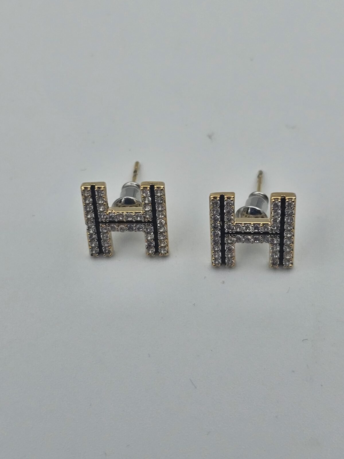 hermes modeli siyah şerit mineli taşlı gold küpe